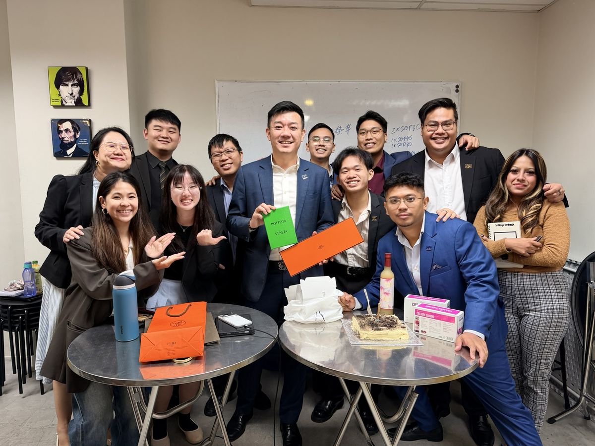 The DC Marketing team around a cake in the office, celebrating a milestone